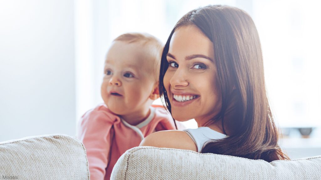 Woman smiling holding a baby (MODELS)